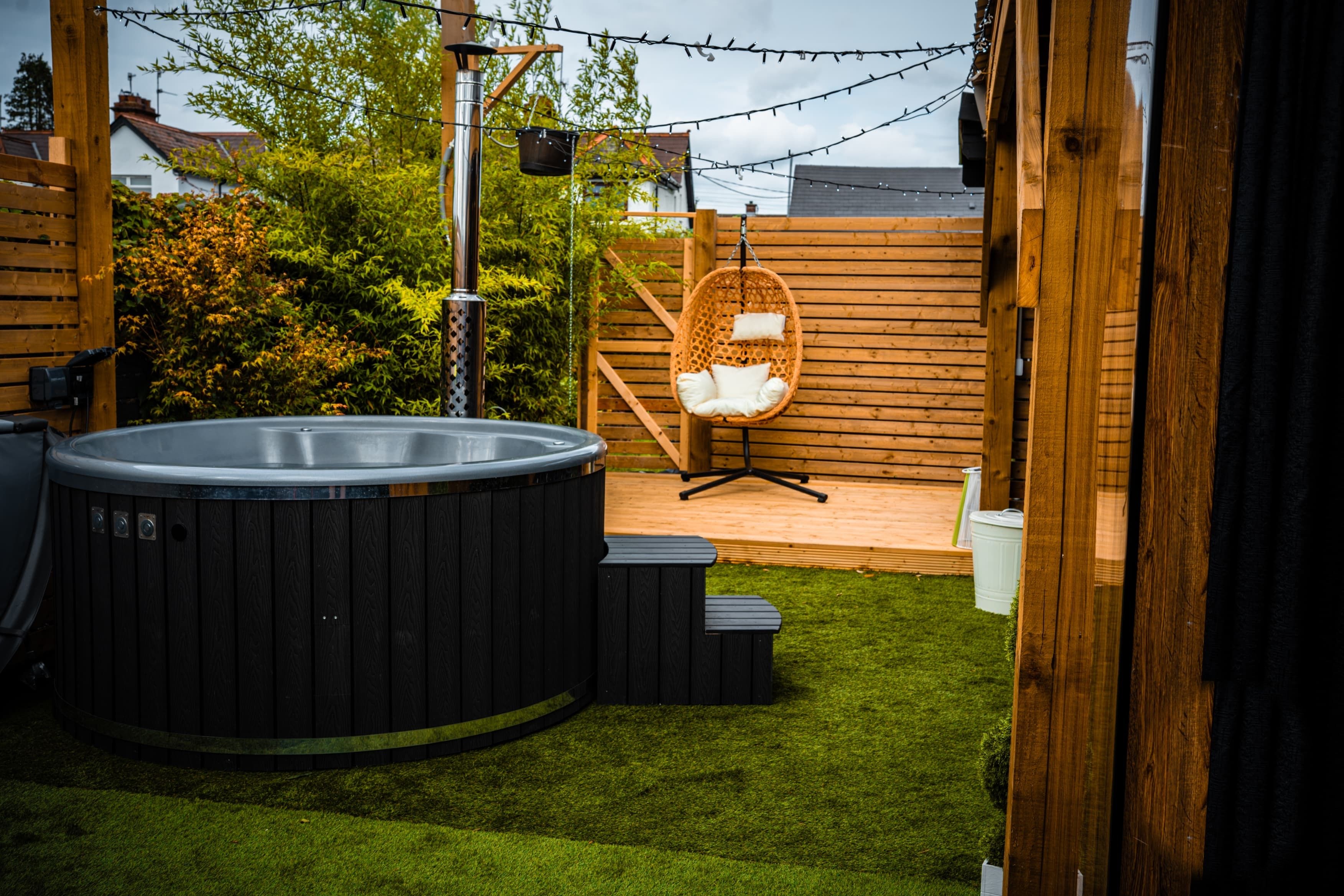 The Recovery Club’s hot tub, timber garden deck and hanging chair in Lurgan.